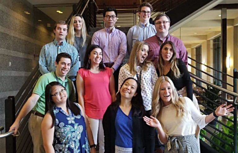 Printpack interns standing on a staircase.